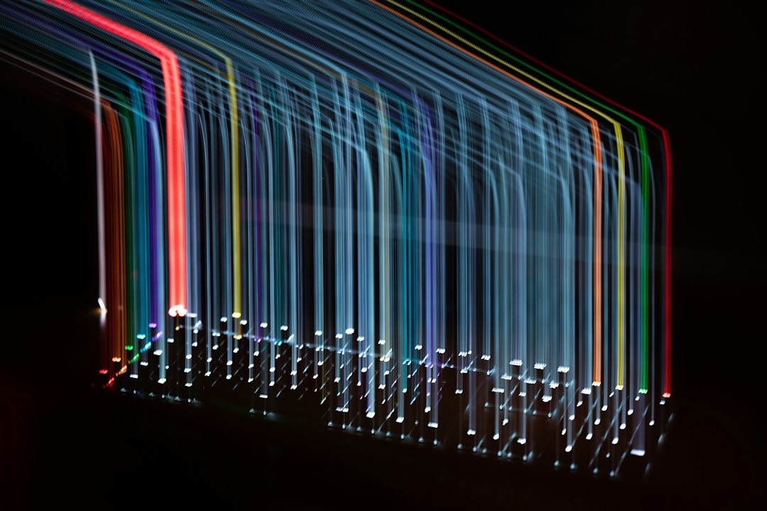 Multi-colored light trails flowing downwards like digital data streams.