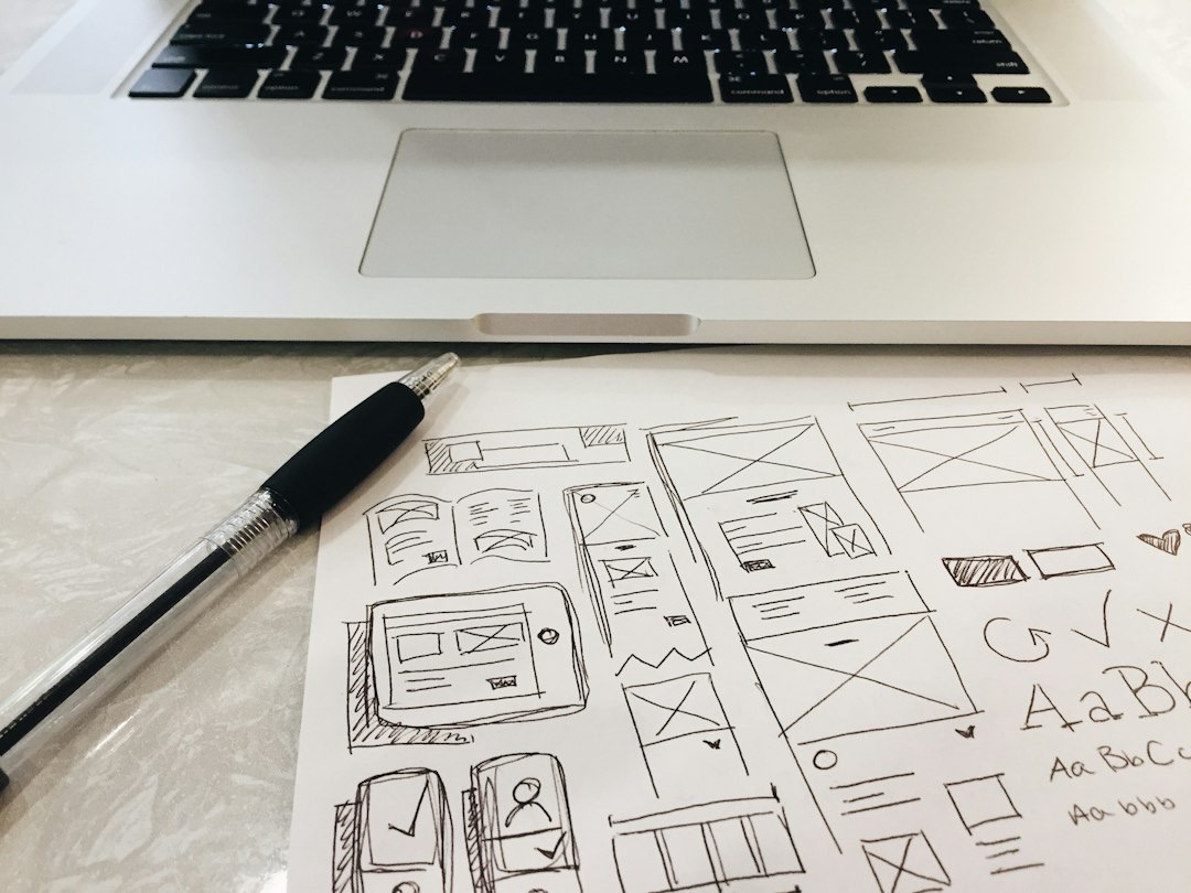 Hand-drawn UI wireframes and sketches on paper with a pen.